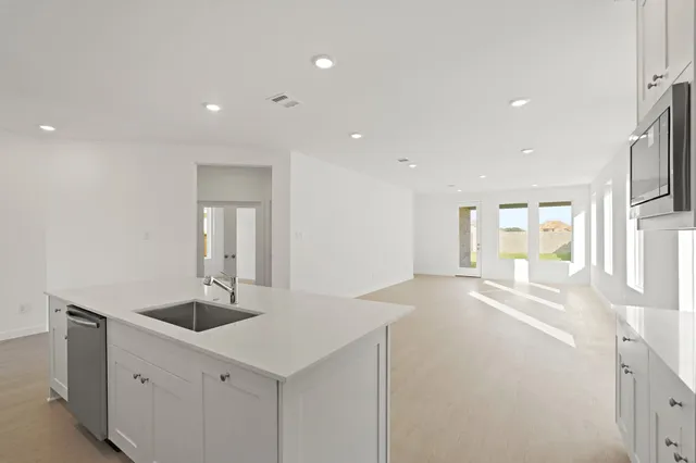 a view of hallway with sink and mirror