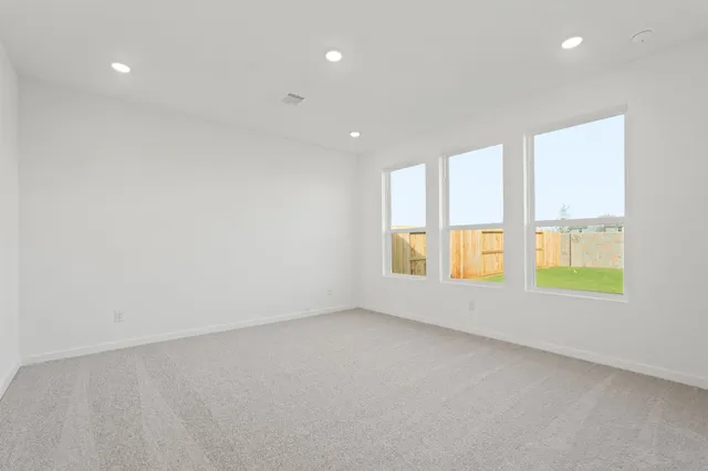 a bedroom with a bed a couch and a potted plant