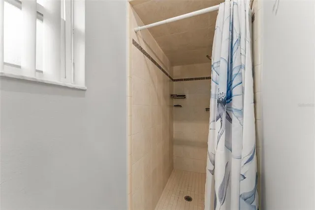 a bathroom with a shower and a mirror