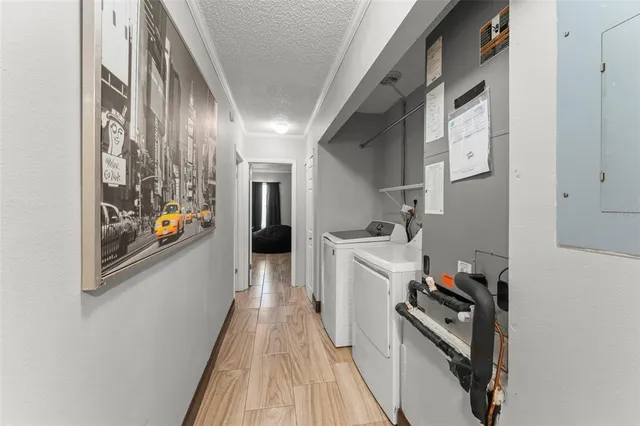 a kitchen with stainless steel appliances a stove top oven a refrigerator a sink and dishwasher with wooden floor