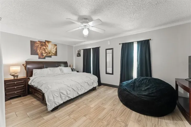 a spacious bedroom with a bed and a chandelier