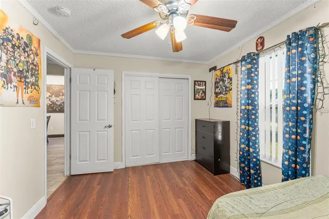 a bedroom with a bed and a chandelier