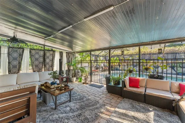 a living room with furniture and a floor to ceiling window