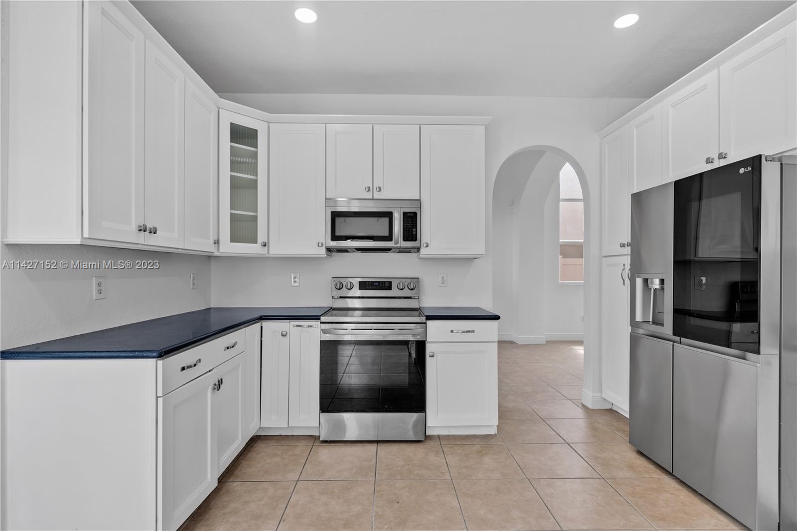 3759 Northeast 15th Street Homestead, FL 33033 - Photo 11 of 55 a kitchen with stainless steel appliances granite countertop a refrigerator and a stove top oven