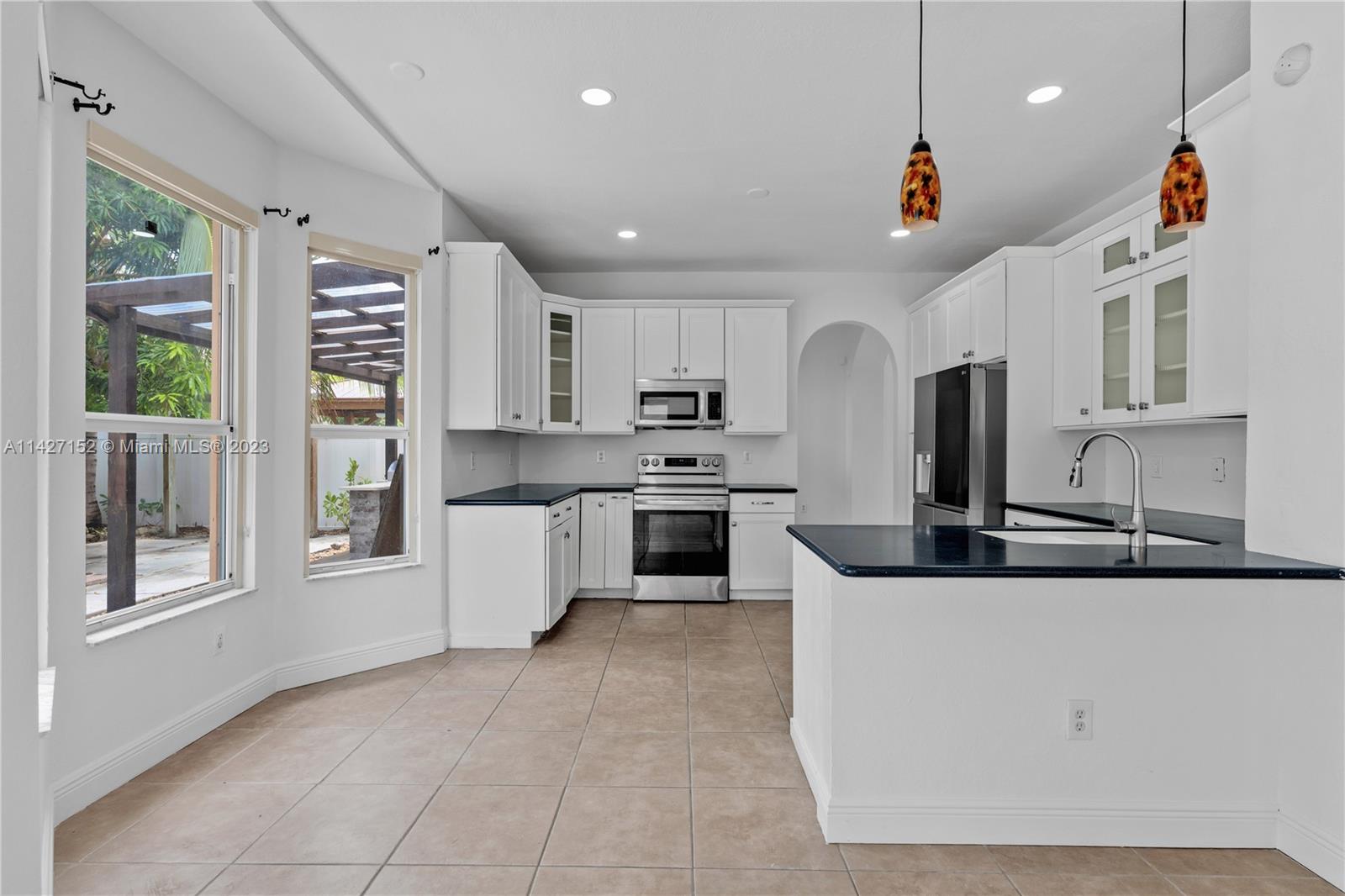 3759 Northeast 15th Street Homestead, FL 33033 - Photo 12 of 55 a kitchen with stainless steel appliances granite countertop a stove and a sink