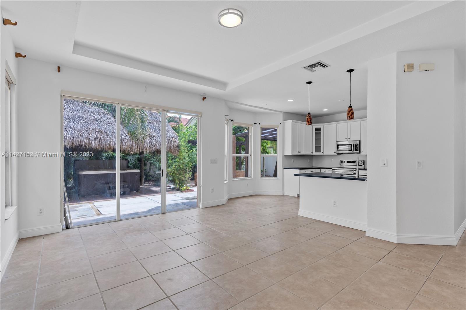 3759 Northeast 15th Street Homestead, FL 33033 - Photo 15 of 55 a large white kitchen with white cabinets and stainless steel appliances