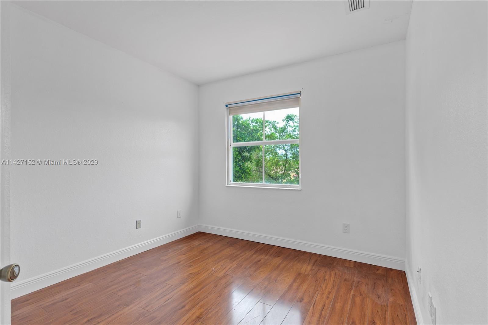 3759 Northeast 15th Street Homestead, FL 33033 - Photo 20 of 55 an empty room with wooden floor and windows