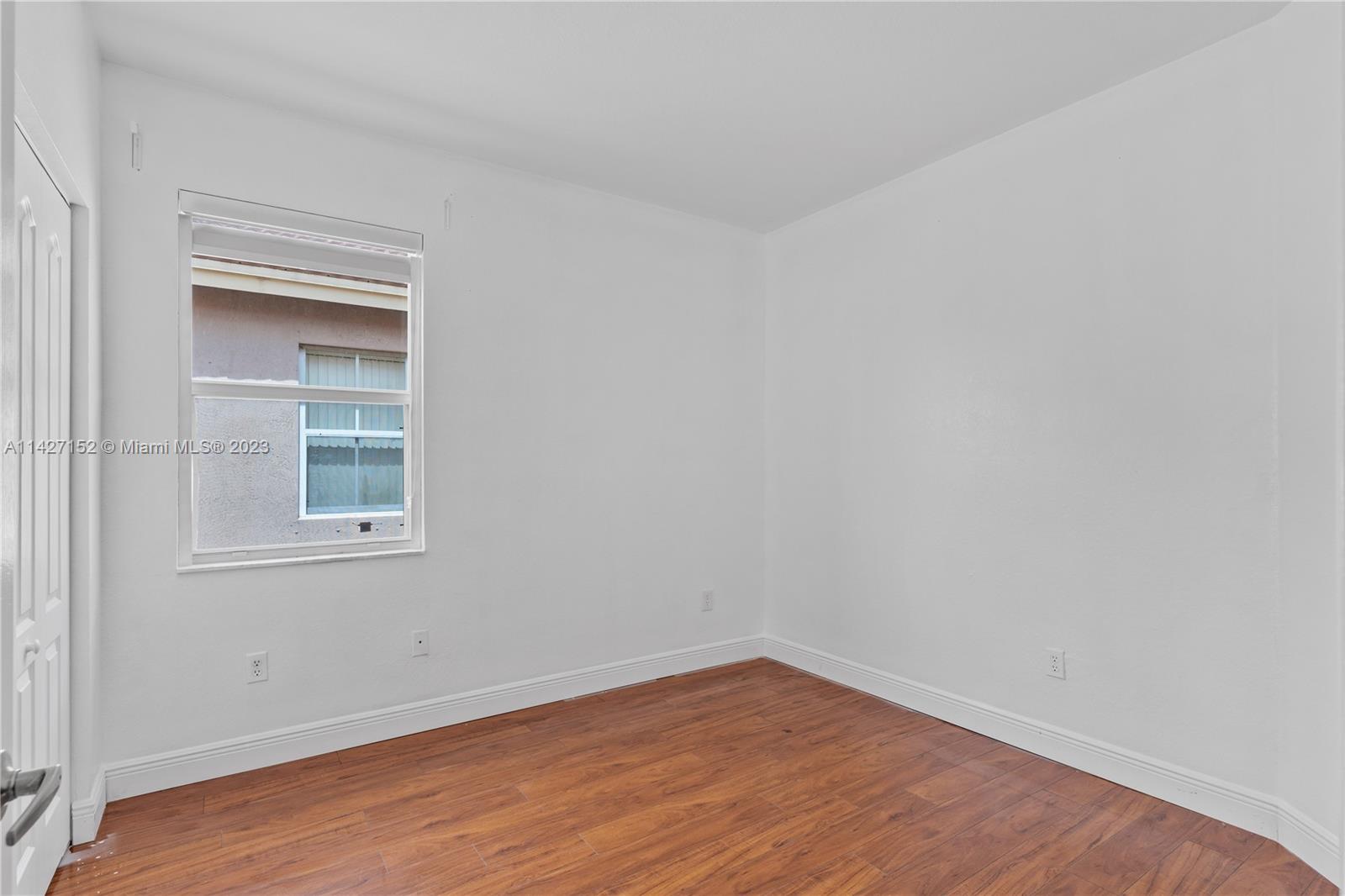3759 Northeast 15th Street Homestead, FL 33033 - Photo 25 of 55 a view of an empty room with wooden floor and a window