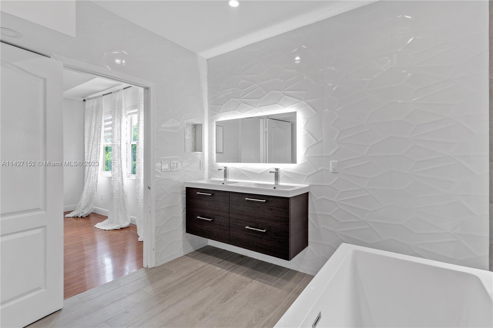 3759 Northeast 15th Street Homestead, FL 33033 - Photo 32 of 55 a bathroom with a double vanity sink toilet mirror and bathtub