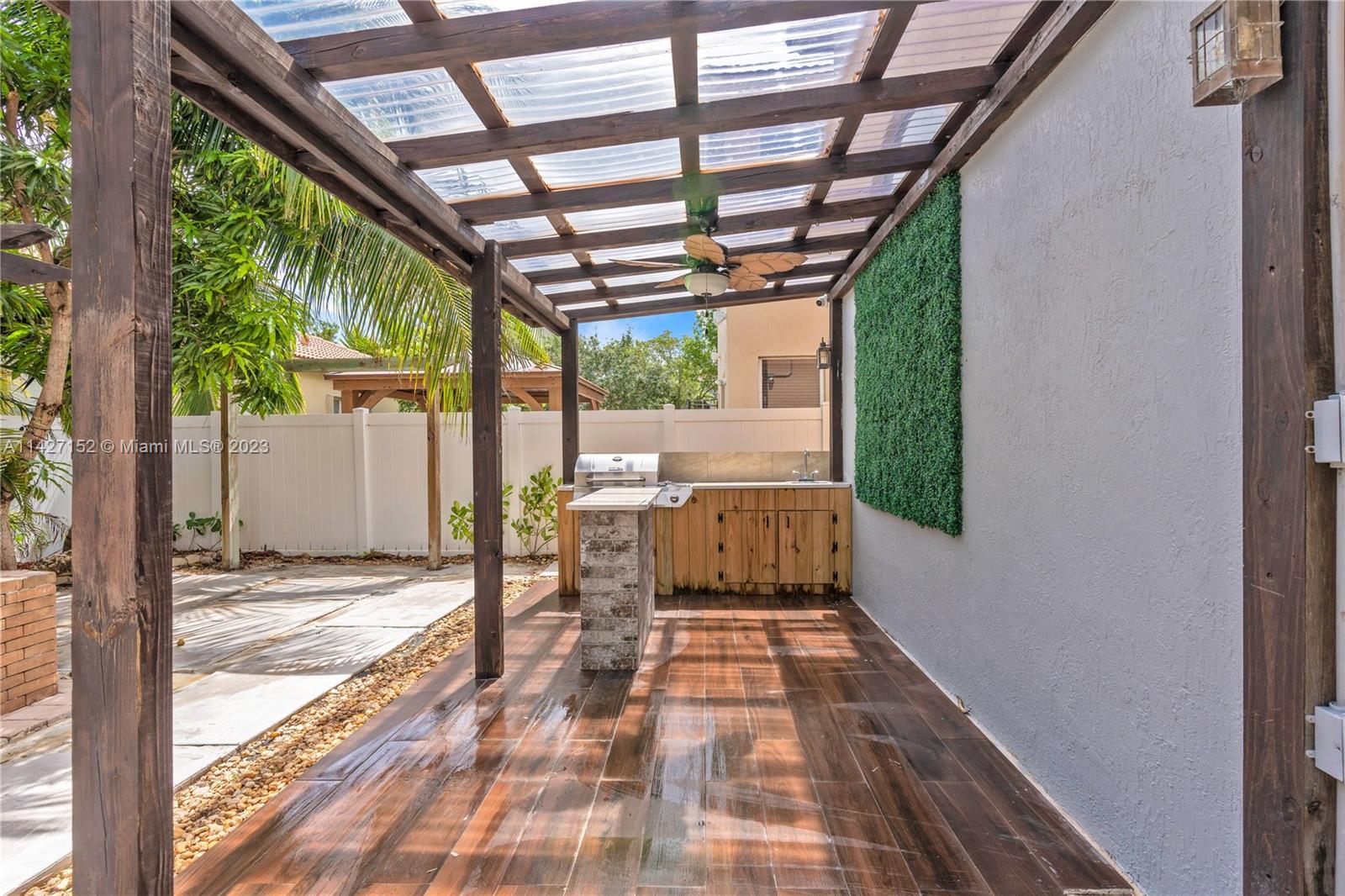 3759 Northeast 15th Street Homestead, FL 33033 - Photo 46 of 55 a porch with a table and chairs next to a yard