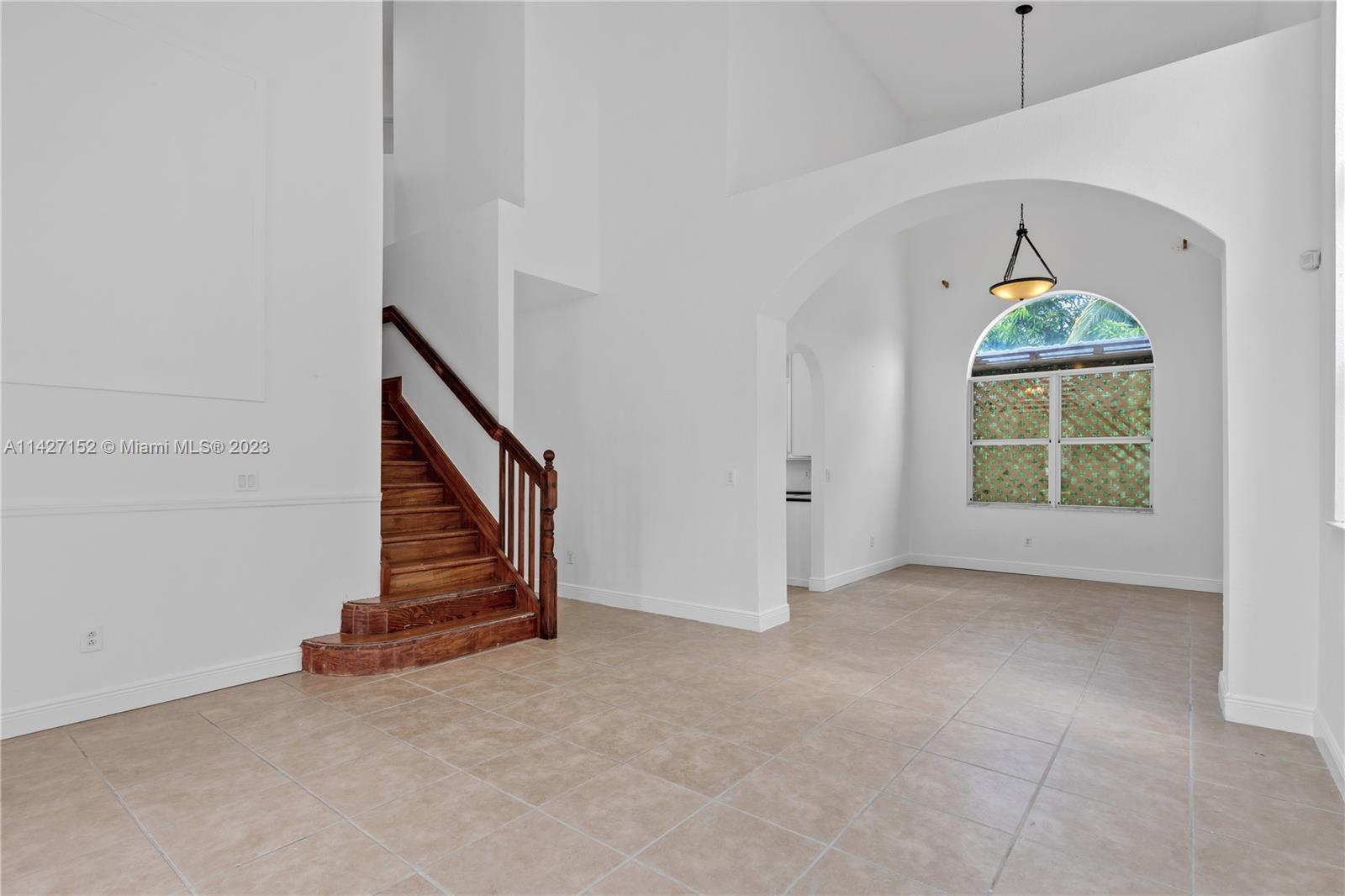 3759 Northeast 15th Street Homestead, FL 33033 - Photo 5 of 55 an empty room with windows and stairs