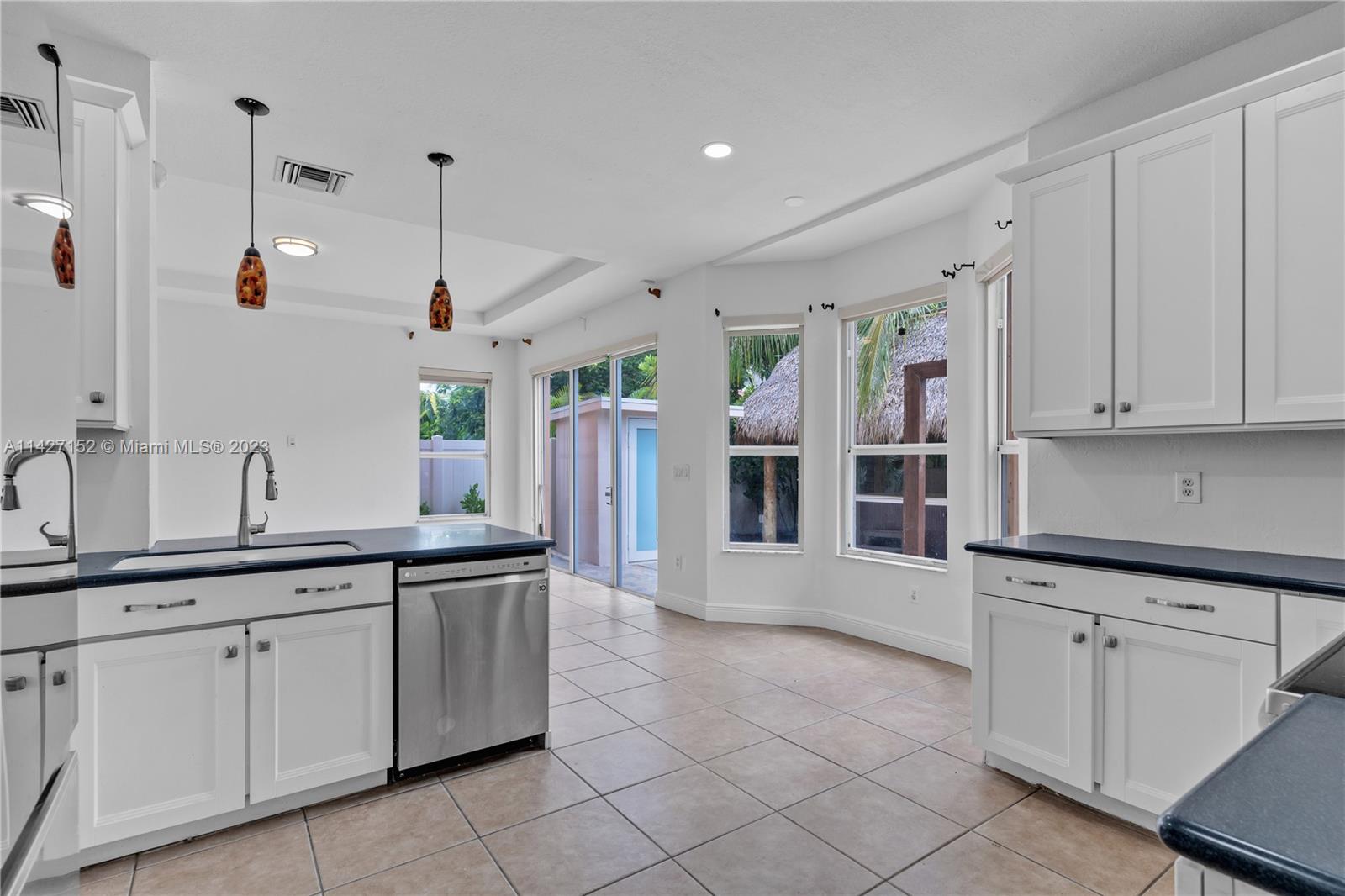 3759 Northeast 15th Street Homestead, FL 33033 - Photo 9 of 55 a large white kitchen with stainless steel appliances granite countertop a sink and cabinets