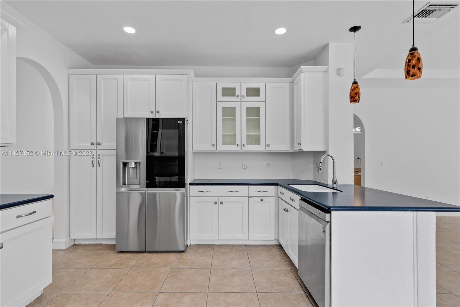 3759 Northeast 15th Street Homestead, FL 33033 - Photo 10 of 55 a kitchen with stainless steel appliances granite countertop a refrigerator and a sink