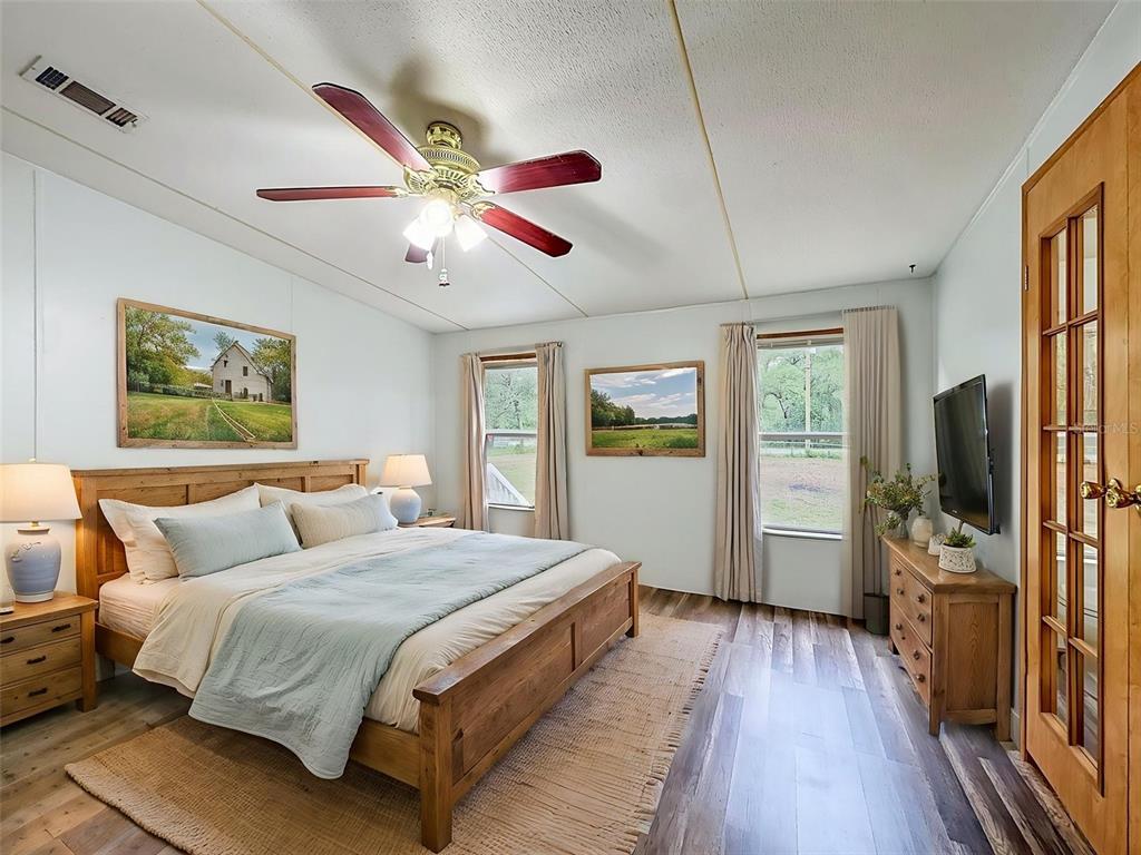 1819 Sinclair Hills Road Lutz, FL 33549 - Photo 28 of 60 a bedroom with a bed and a flat screen tv