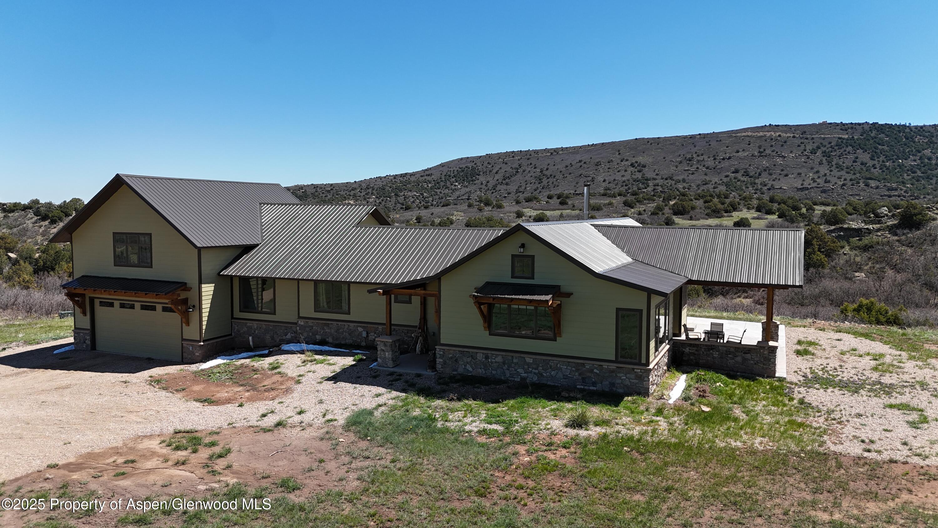 741 Big Wall Lane La Veta, CO 81055 - Photo 11 of 47 a front view of a house with a yard