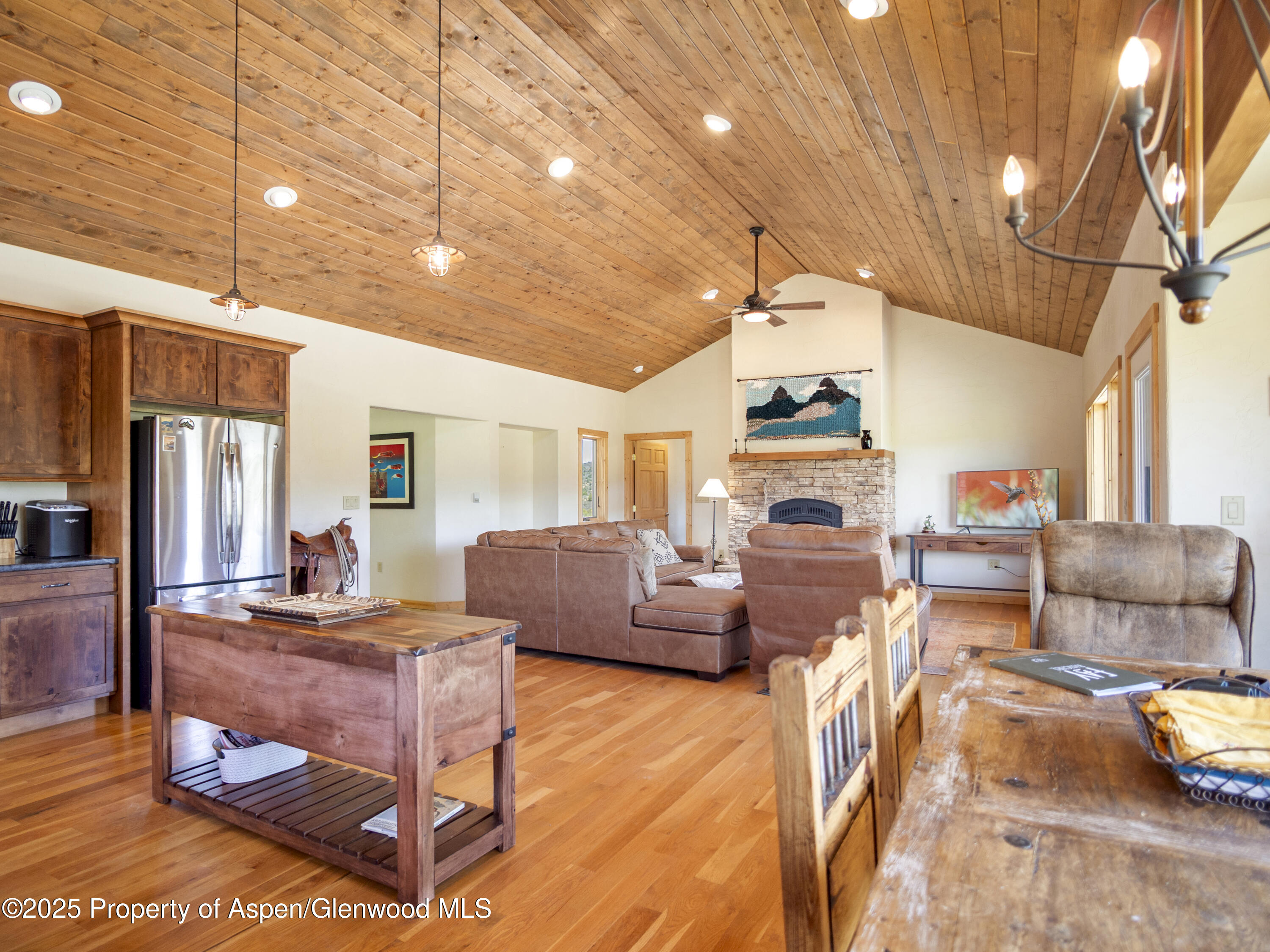 741 Big Wall Lane La Veta, CO 81055 - Photo 29 of 47 a living room with fireplace furniture and a chandelier