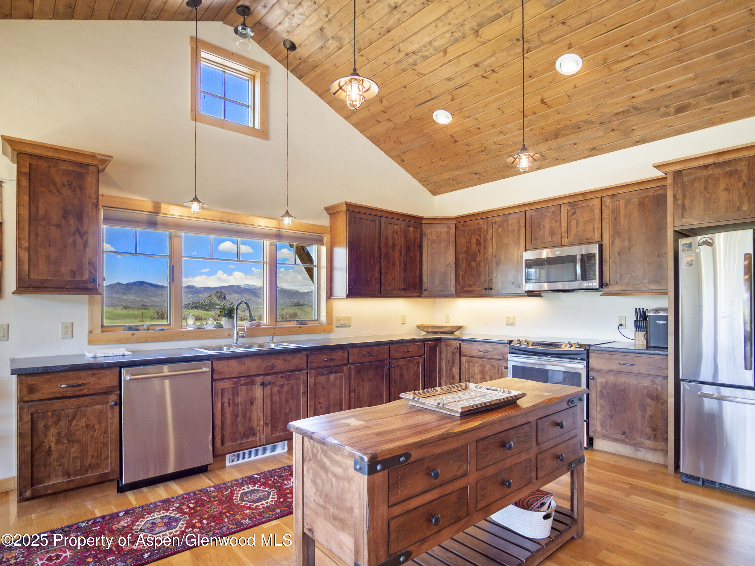 741 Big Wall Lane La Veta, CO 81055 - Photo 35 of 47 a kitchen with stainless steel appliances granite countertop a stove a sink dishwasher and a refrigerator