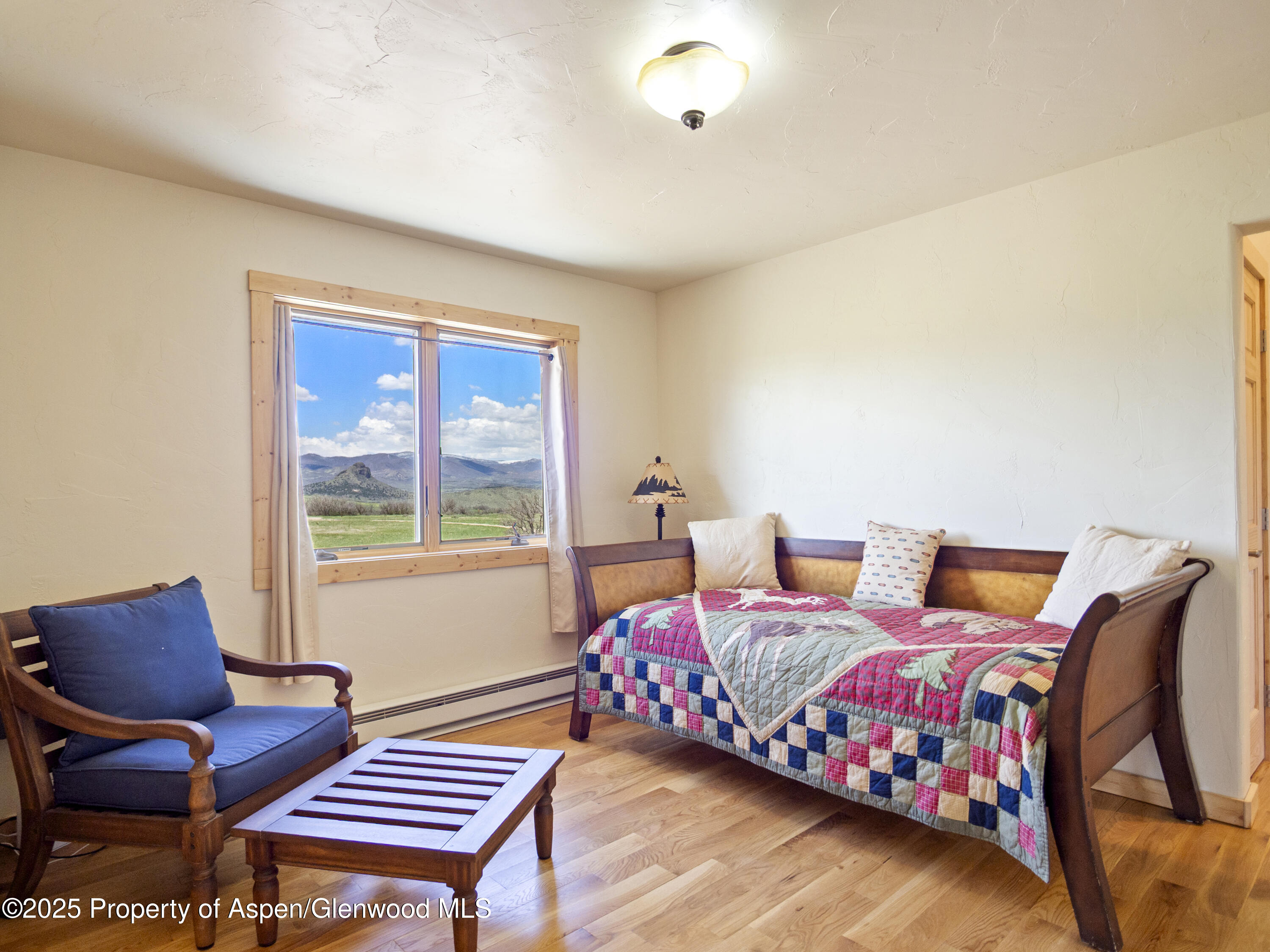 741 Big Wall Lane La Veta, CO 81055 - Photo 39 of 47 a bedroom with a bed and chair