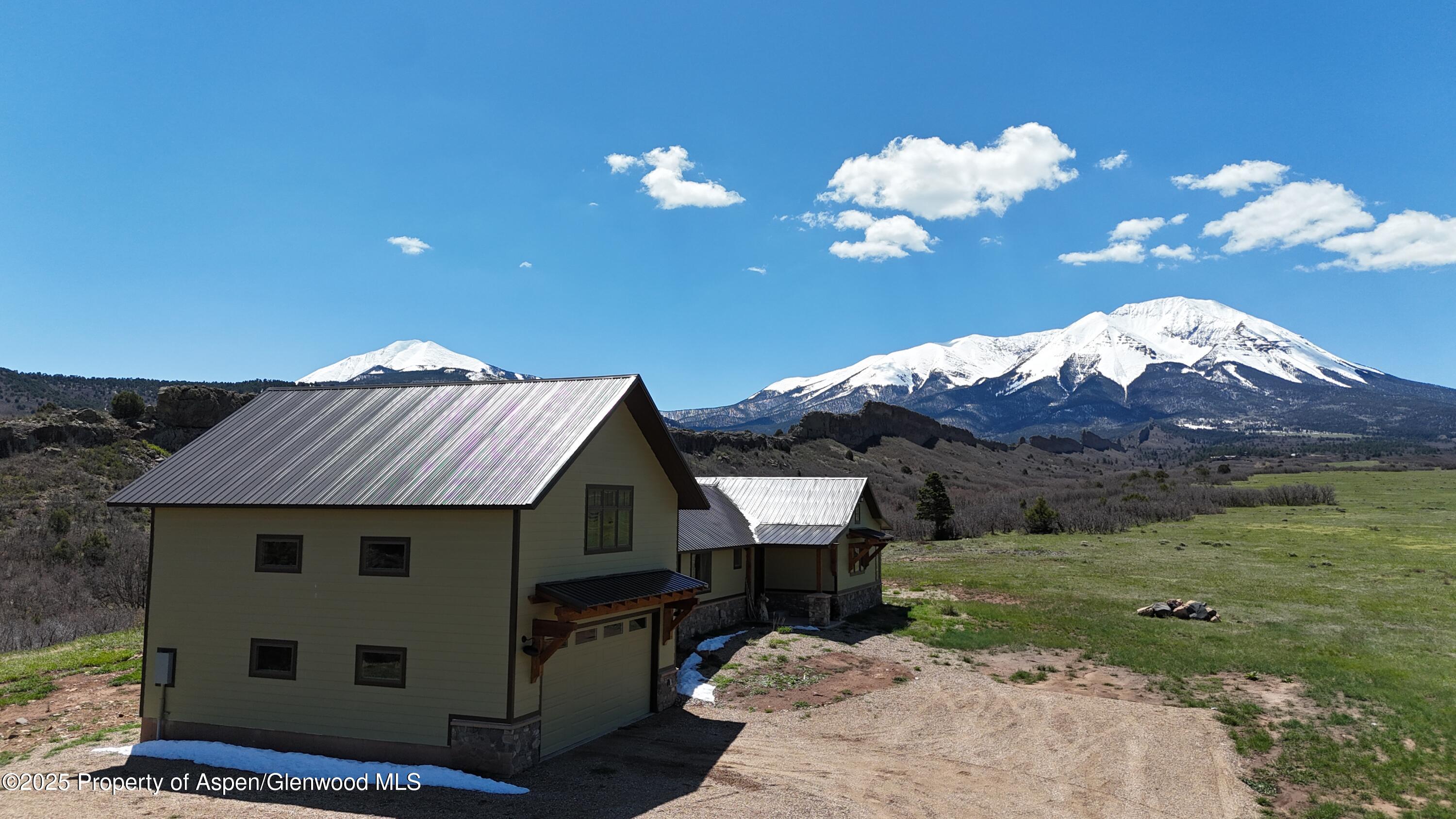 741 Big Wall Lane La Veta, CO 81055 - Photo 9 of 47 a front view of a house with garden