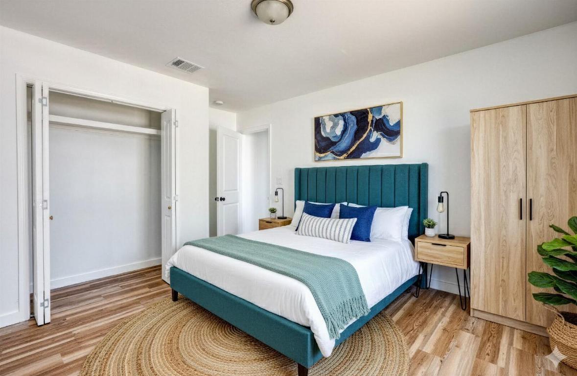 4905 Nesting Way Austin, TX 78744 - Photo 11 of 17 a bedroom with a bed and a potted plant