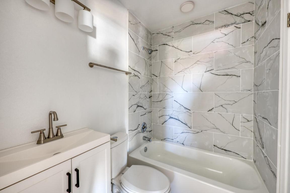 4905 Nesting Way Austin, TX 78744 - Photo 16 of 17 a bathroom with a sink toilet and shower