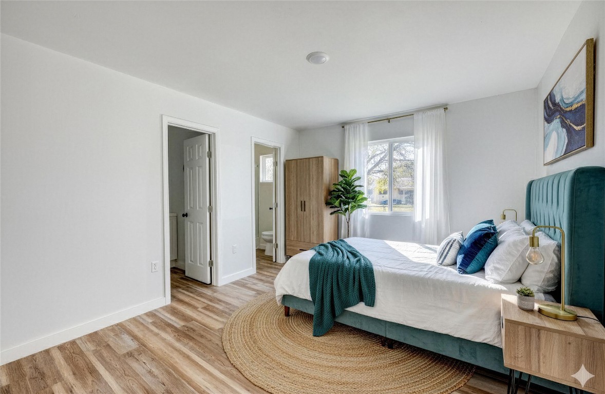 4905 Nesting Way Austin, TX 78744 - Photo 7 of 17 a bedroom with a bed and large windows