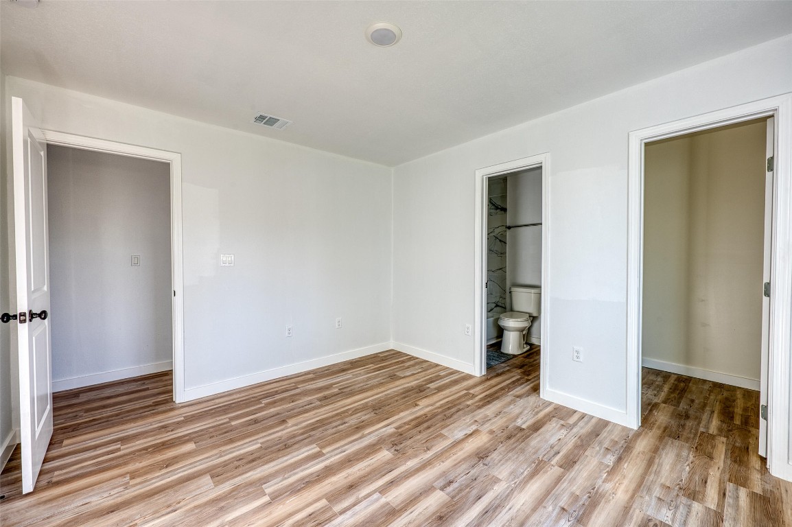 4905 Nesting Way Austin, TX 78744 - Photo 9 of 17 a view of empty room with wooden floor