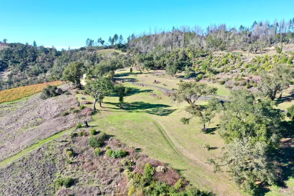 a view of a house with a yard and mountain