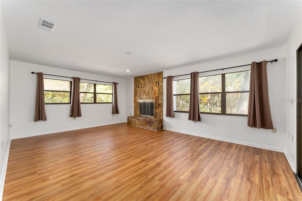 20290 Southwest 97th Place Dunnellon, FL 34431 - Photo 13 of 73 wooden floor in an empty room with a window