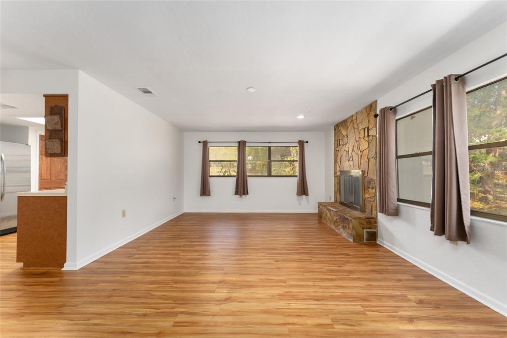20290 Southwest 97th Place Dunnellon, FL 34431 - Photo 14 of 73 a view of an empty room with wooden floor and a window