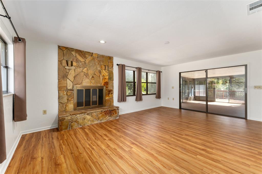 20290 Southwest 97th Place Dunnellon, FL 34431 - Photo 16 of 73 a view of an empty room with wooden floor and a window