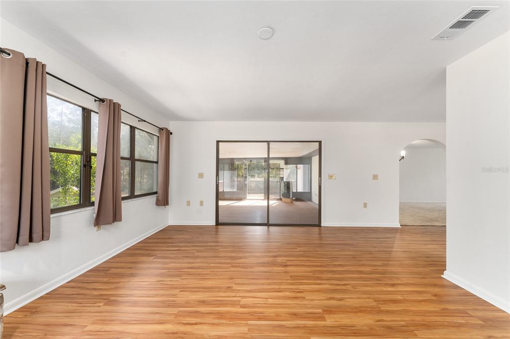 20290 Southwest 97th Place Dunnellon, FL 34431 - Photo 18 of 73 a view of empty room with wooden floor and fan