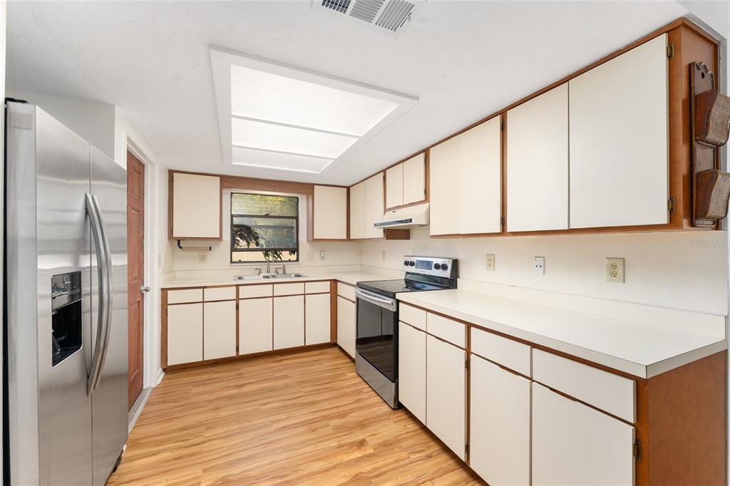 20290 Southwest 97th Place Dunnellon, FL 34431 - Photo 10 of 73 a kitchen with white cabinets stainless steel appliances and sink