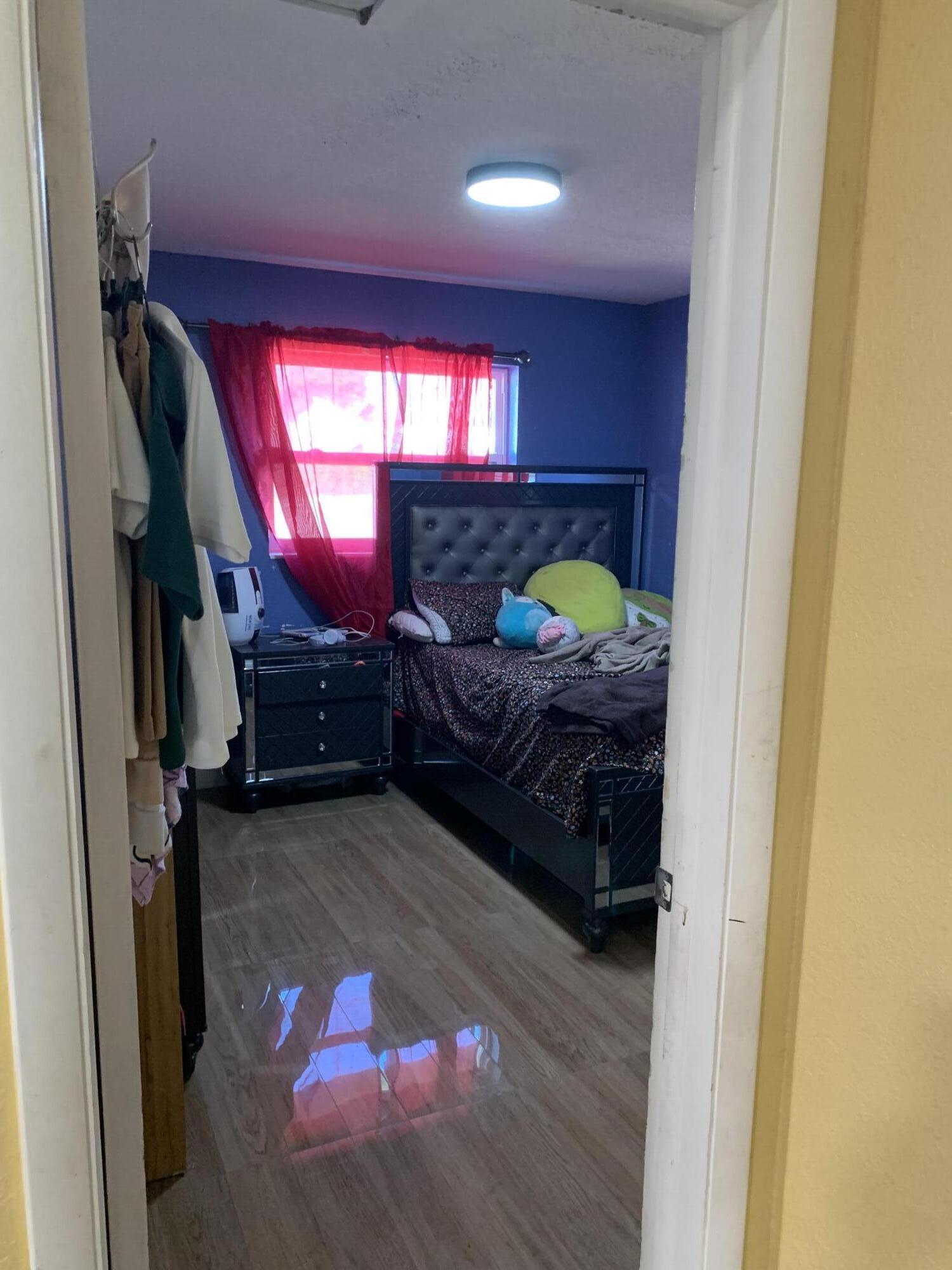 1014 Old Boynton Road Boynton Beach, FL 33426 - Photo 3 of 10 a bedroom with a bed window and dresser