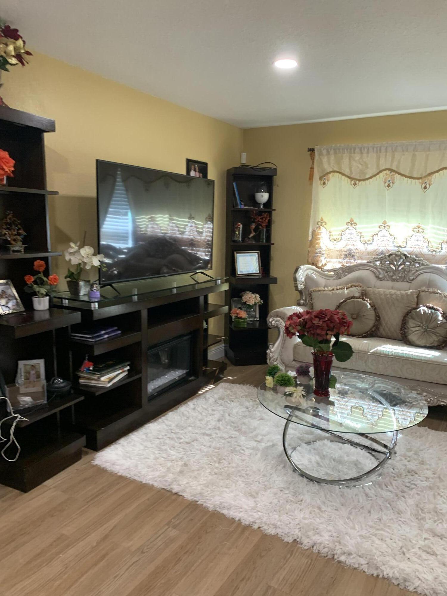 1014 Old Boynton Road Boynton Beach, FL 33426 - Photo 6 of 10 a room with furniture and a flat screen tv