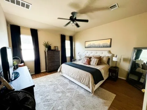 a bedroom with a bed and a chandelier