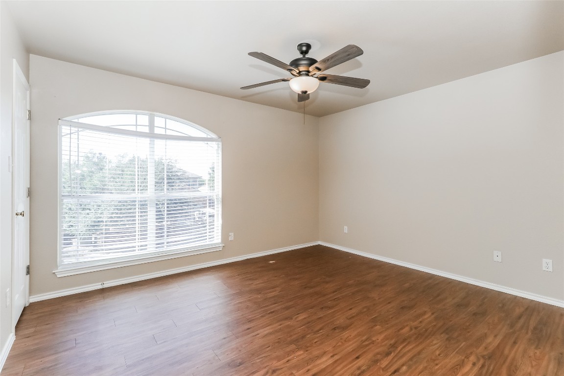 3816 Bandice Lane Pflugerville, TX 78660 - Photo 16 of 18 a view of a big room with wooden floor and windows