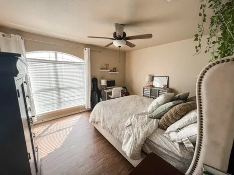 a bedroom with a bed and a window