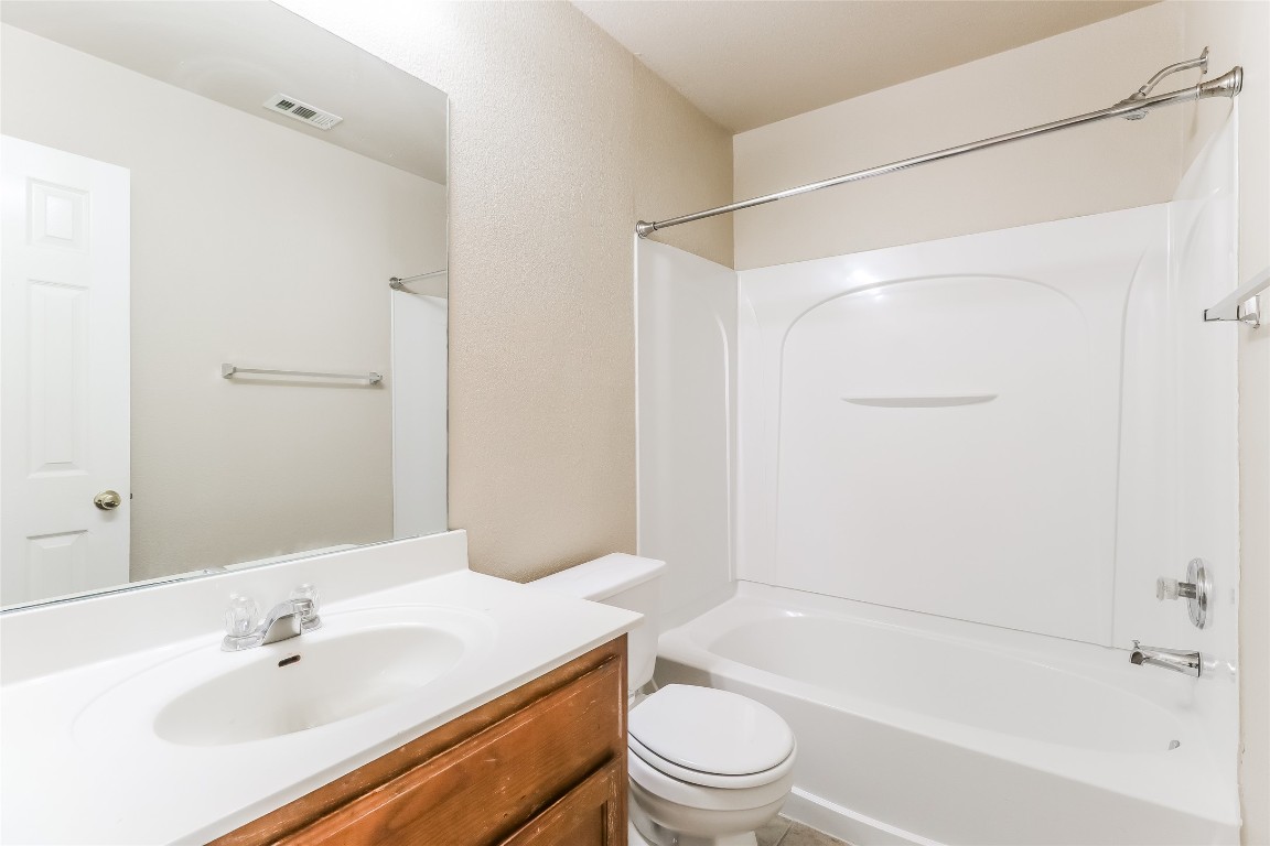 3816 Bandice Lane Pflugerville, TX 78660 - Photo 17 of 18 a bathroom with a bathtub shower sink vanity and toilet