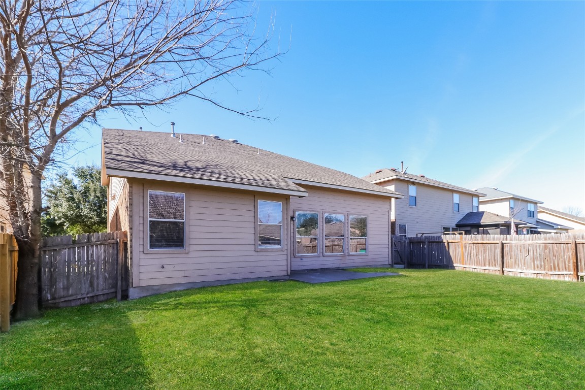 3816 Bandice Lane Pflugerville, TX 78660 - Photo 18 of 18 a view of a backyard with wooden fence and a fence