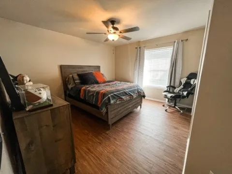 a bedroom with bed chair and window