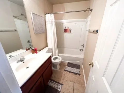 a bathroom with a white bath tub a sink and a mirror