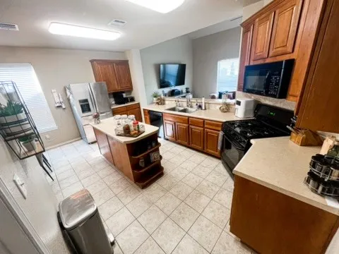 a kitchen with a sink appliances and cabinets