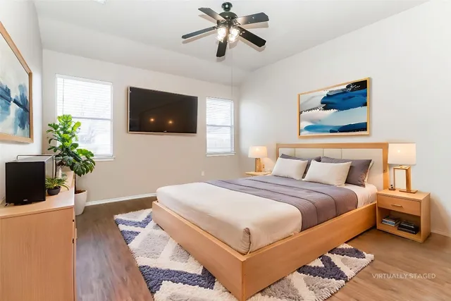 a bedroom with a bed and a flat screen tv