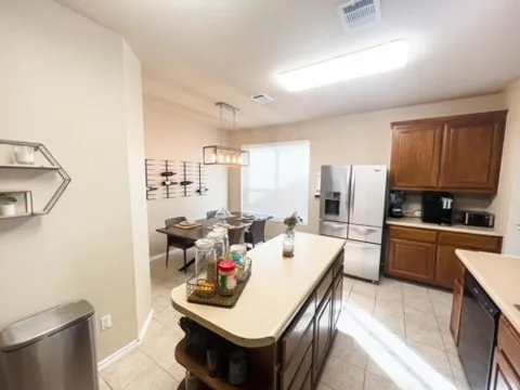 a living room with stainless steel appliances kitchen island granite countertop furniture and a kitchen view
