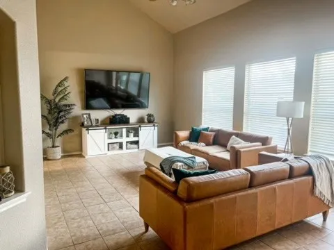 a living room with furniture and a flat screen tv