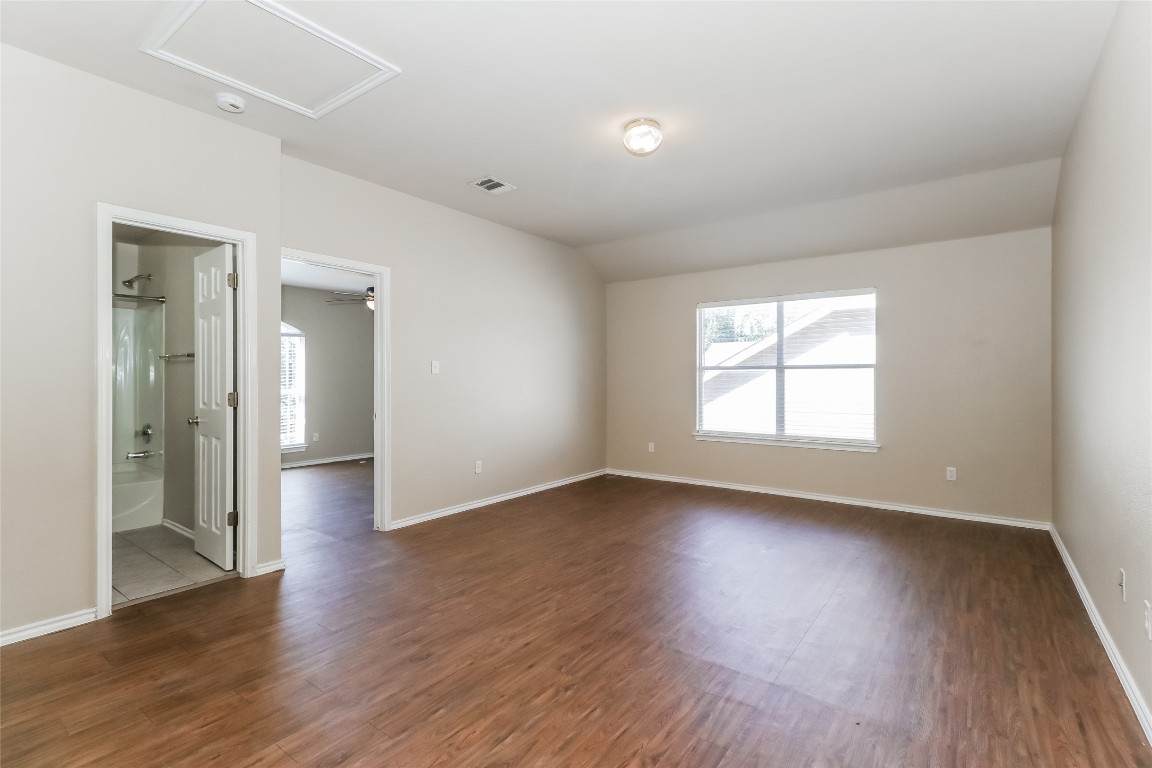 3816 Bandice Lane Pflugerville, TX 78660 - Photo 8 of 18 an empty room with wooden floor and windows