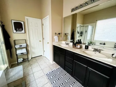 a spacious bathroom with a double vanity sink mirror and