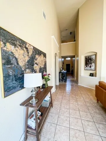 a living room with furniture and a floor to ceiling window