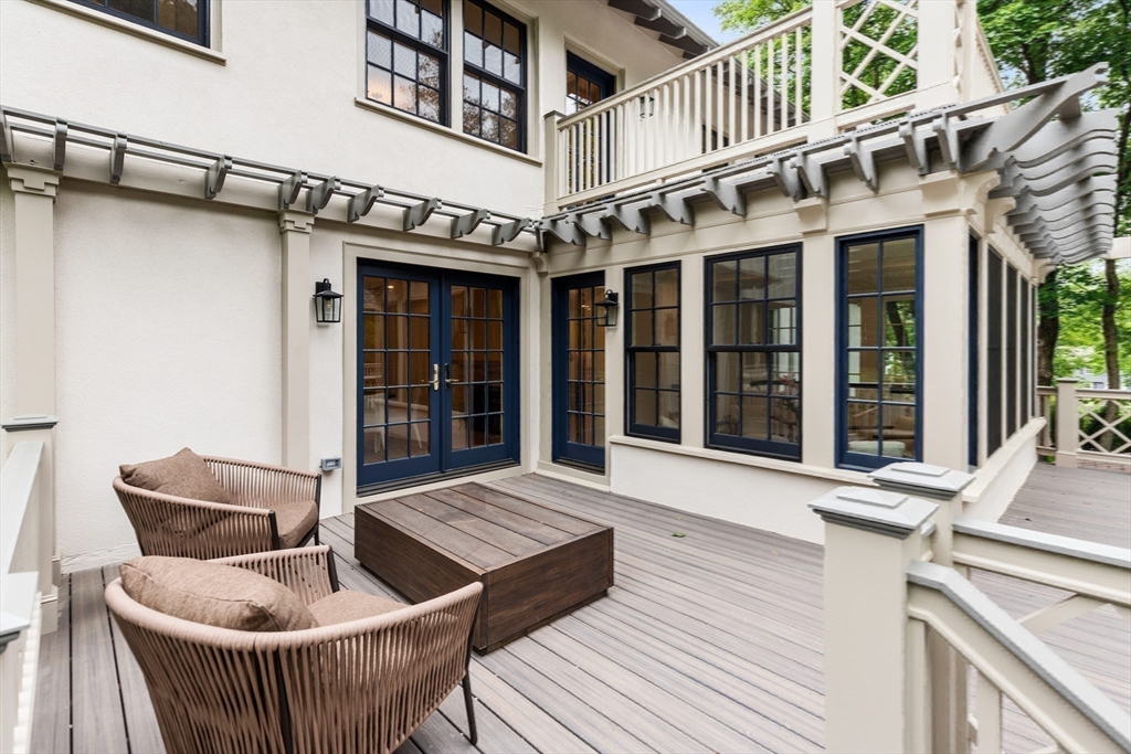 2 Percy Road Lexington, MA 02421 - Photo 11 of 31 a view of brick house with large windows and a table